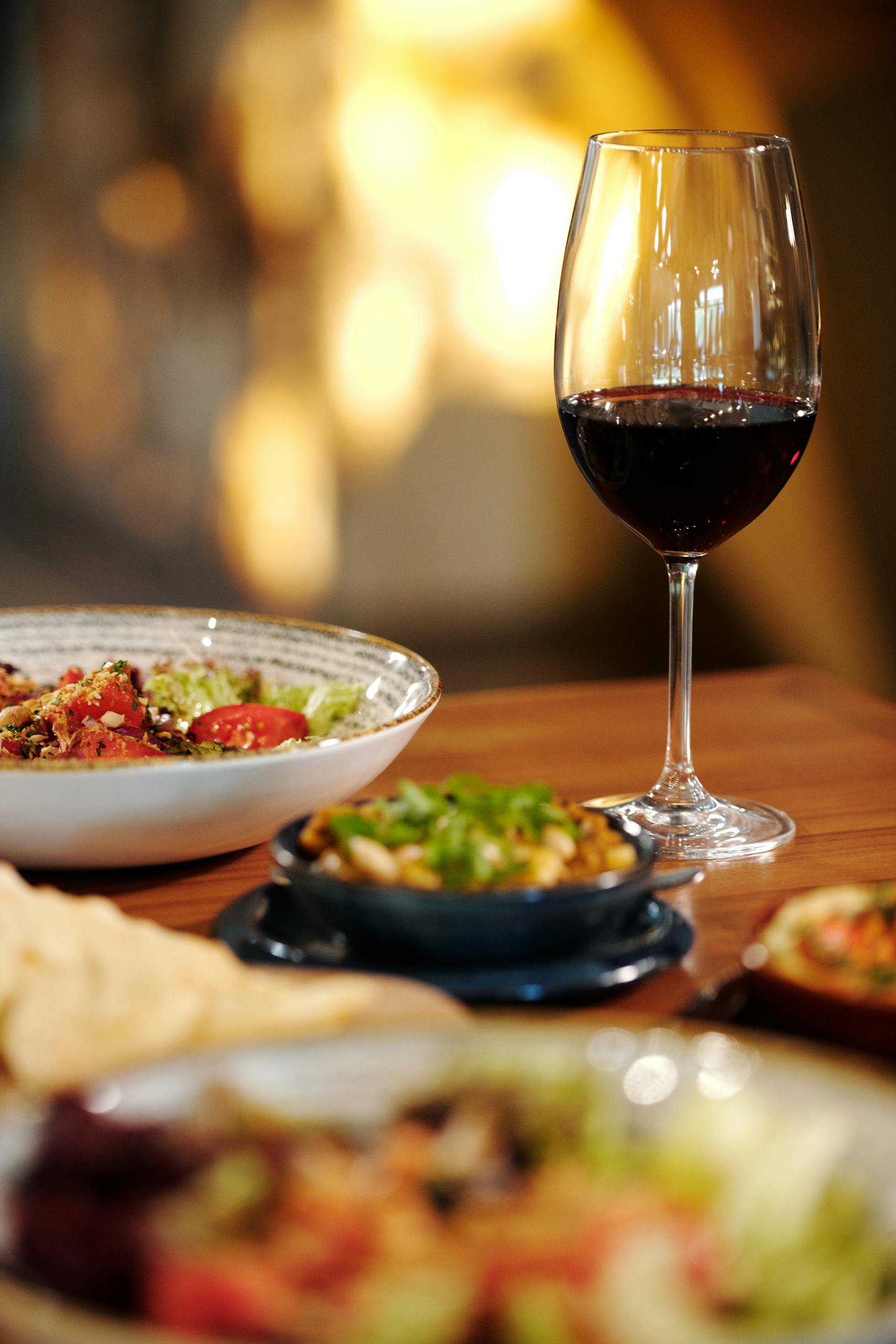 Clear Wine Glass With Red Wine on Brown Wooden Table